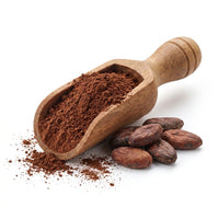 Cocoa powder in a wooden scoop with cacao beans